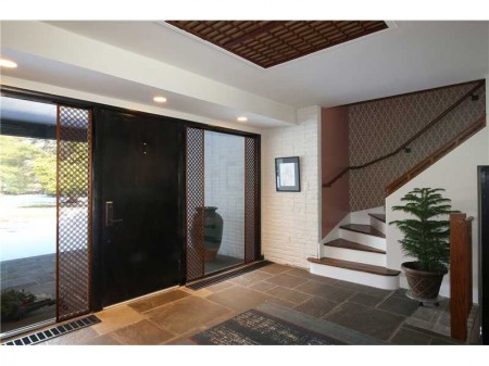 Huge front door and impressive front hall way paves the way to living in a very gracious and chic mid-century modern.