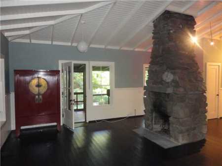 Open Livingroom with large stone fireplace.