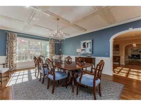 The dining room that has enough wall space to wrap some fabulous wall paper around it.  To say nothing of the dining room table and chairs you will be looking for.  Dinner for 18.