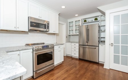 Love the way they kept the old pantry in tact around the refrigerator. 